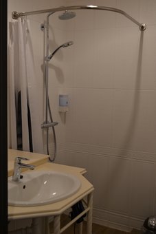 A bathroom with a shower in the room of the Michel hotel in Odessa. Book at a discount.