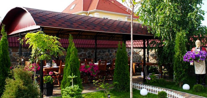 Summer terrace at the Sofiyivsky Posad restaurant in Kiev. Order at a discount