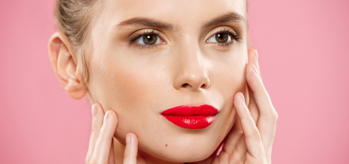 https://cdn1.pokupon.ua/uploaded/new_campaign_pictures/935606/data/main720x340/beauty-concept-woman-applying-red-lipstick-with-pink-studio-background-beautiful-girl-makes-makeup.jpg?1744626494